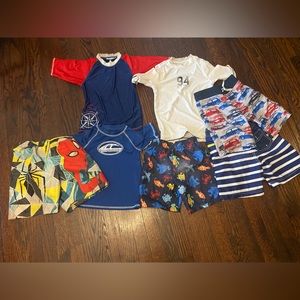 A lot of toddler swim trunks and tops